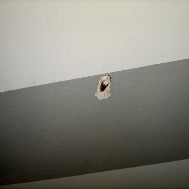 Bullet from the Army shooting range lodged inside the wall of a building.