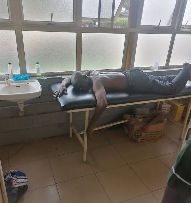 Baba Ajeri, lying on his back inside the Army barracks